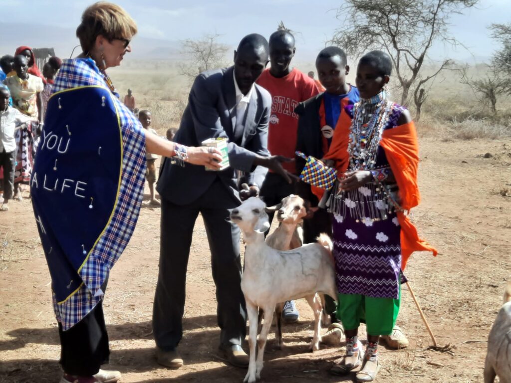 joyce tannian handing off goats and a grant to a widow