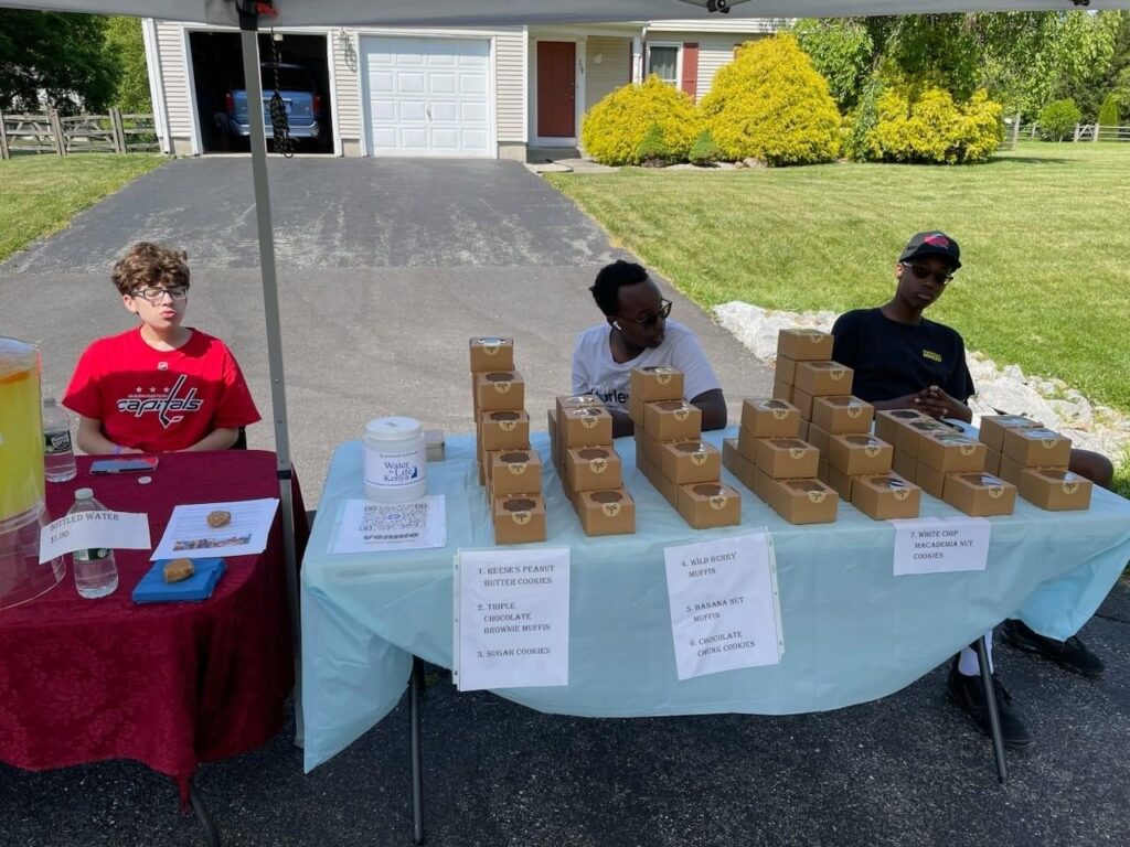 Michael and Nathan selling baked goods to raise money for their service project to Kenya.